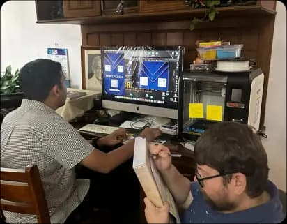 Child writing on board with teacher